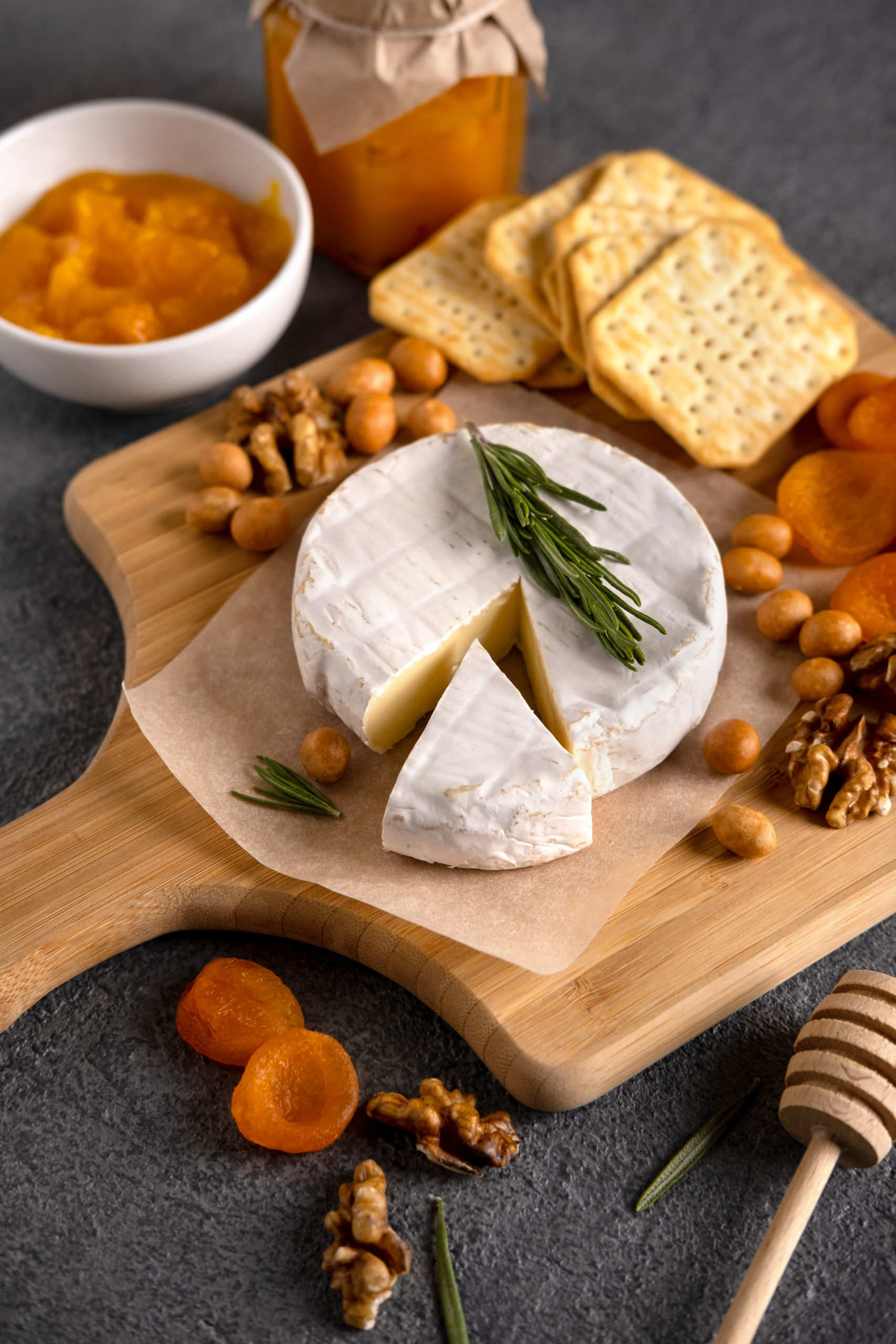 Brie cheese with nuts, pear slices and dried apricots. Camembert
